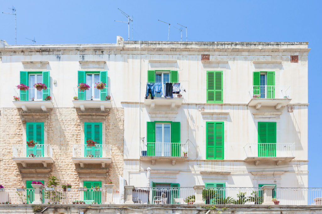 Molfetta, Apulia, Italy - Green window shutters at the historical facades in Molfetta