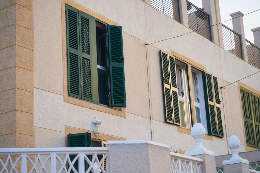 Green shutters on windows. Spanish house.