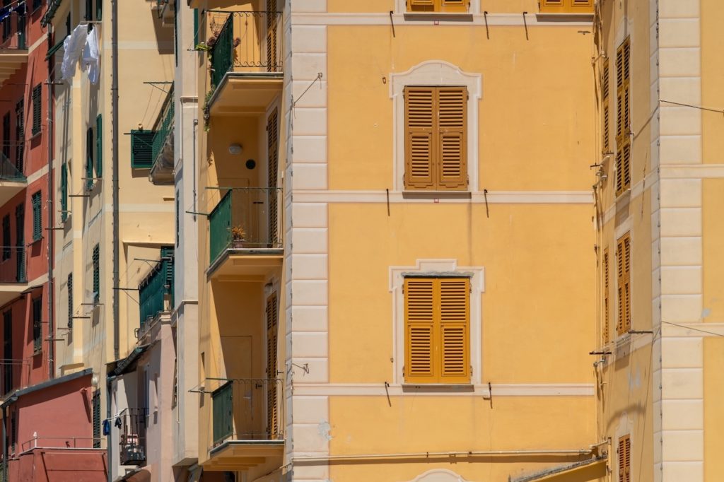 Shuttered windows and colorful residential buildings in the seaside town of Camogli, Italy. .