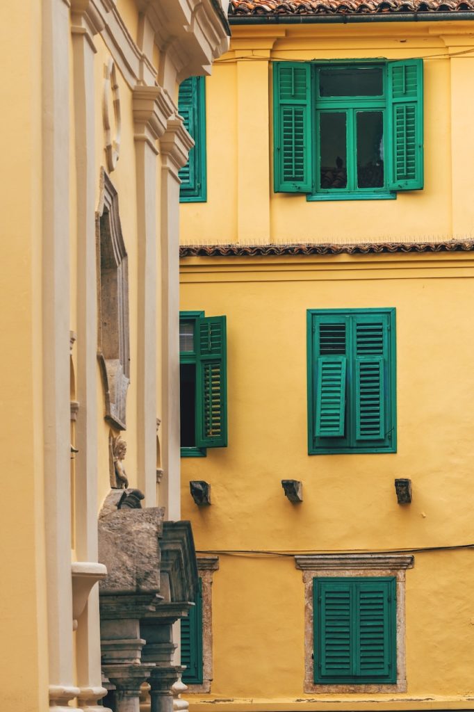 Lovran architecture, old building with vintage window shutters. Lovran is a town in croatian Kvarner bay of Adriatic sea, touristic travel destination with distinctive Istrian architectural style.